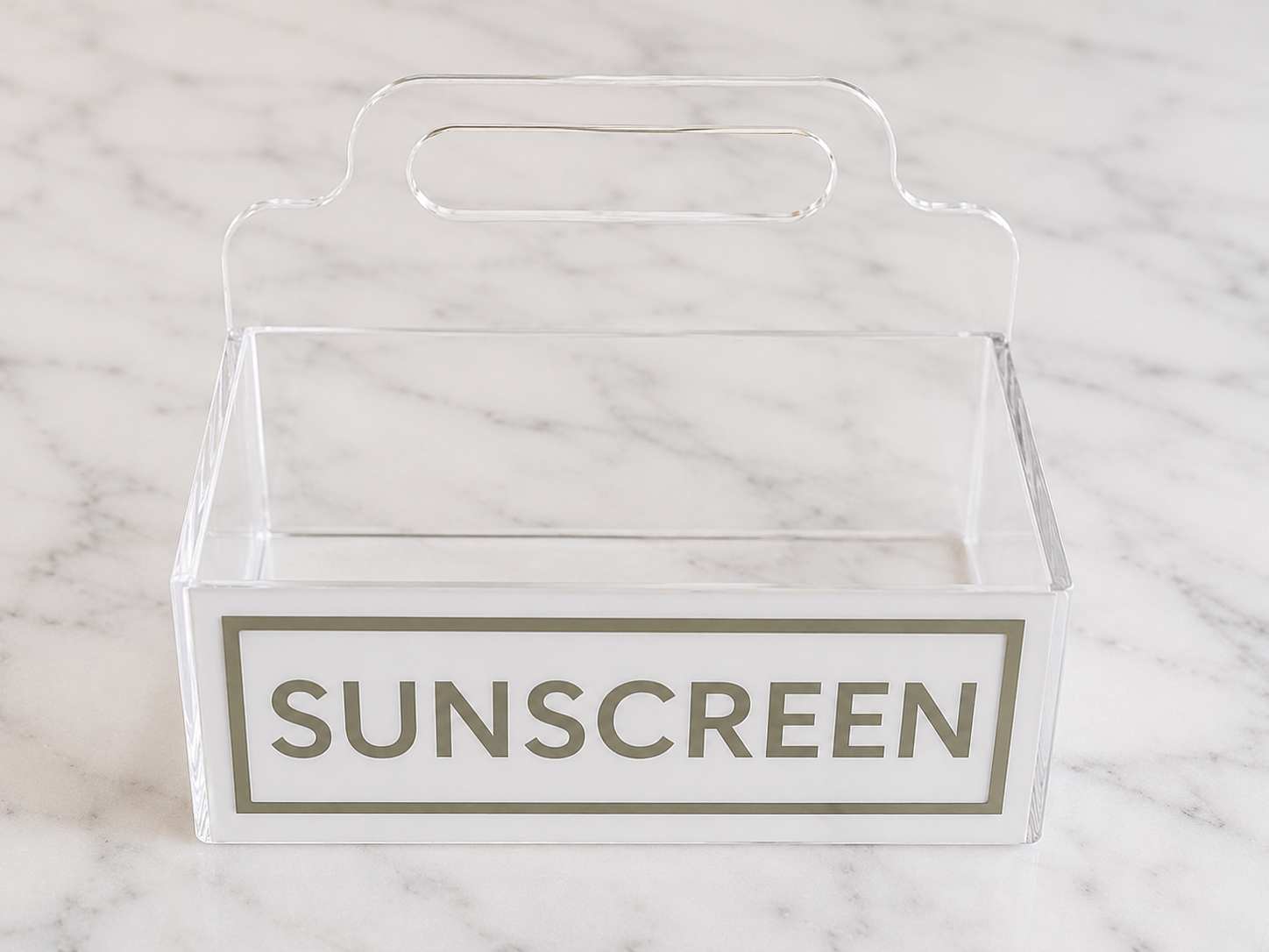 Clear acrylic sunscreen caddy with a custom nameplate, perfect for poolside organizing.